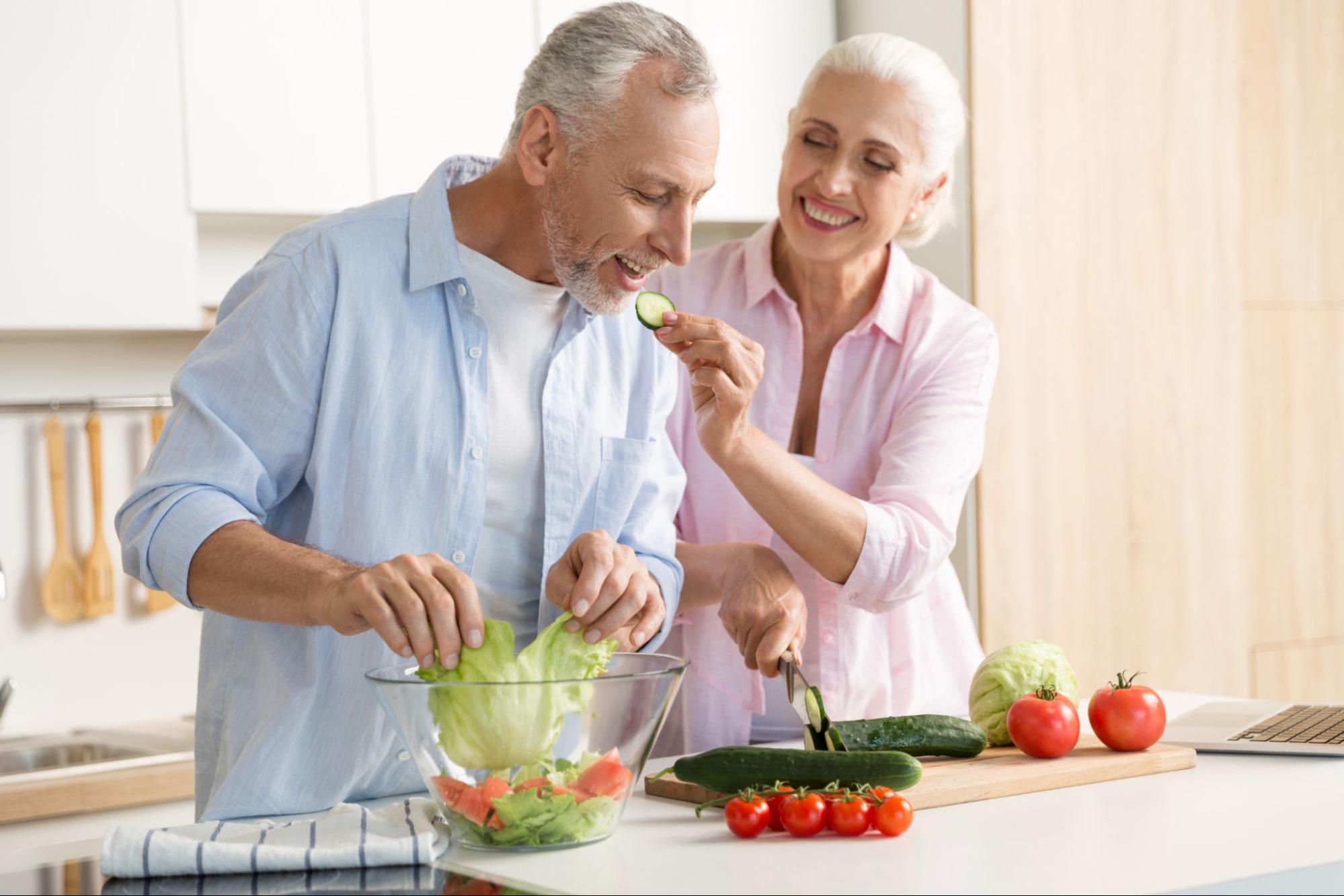 10 Healthy Eating Habits To Try Now 5 Mature couple having fun in their kitchen making a salad together