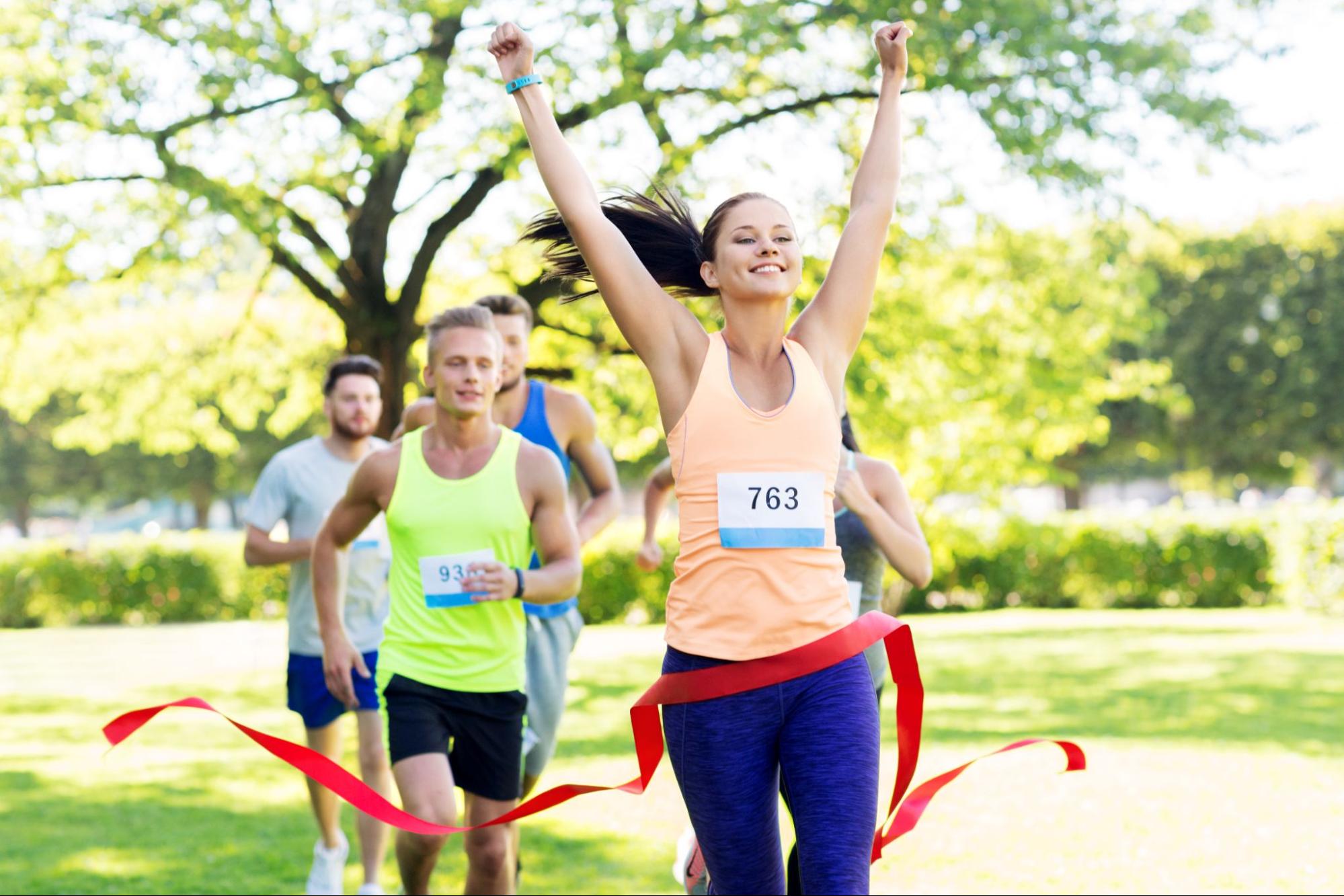 5 Ways Exercise Boosts Your Self-Esteem 3 Happy woman running through the finish line as she wins the race